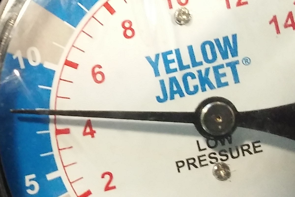 Calibrated low-pressure manometer reading regulator output in inches of water column during an on-site LP gas drop-pressure test.