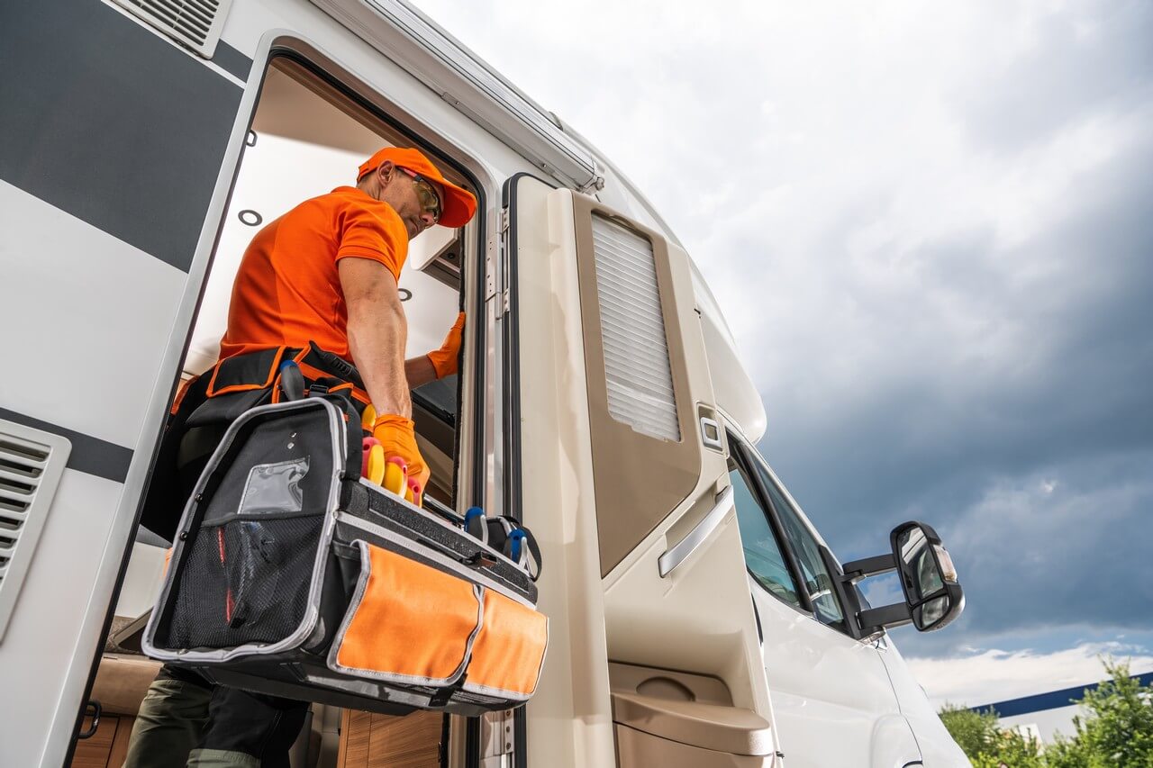 192 Mobile RV Repair technician loading a tool bag into an RV during an on-site service call